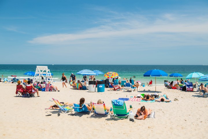 a group of people sitting at a beach