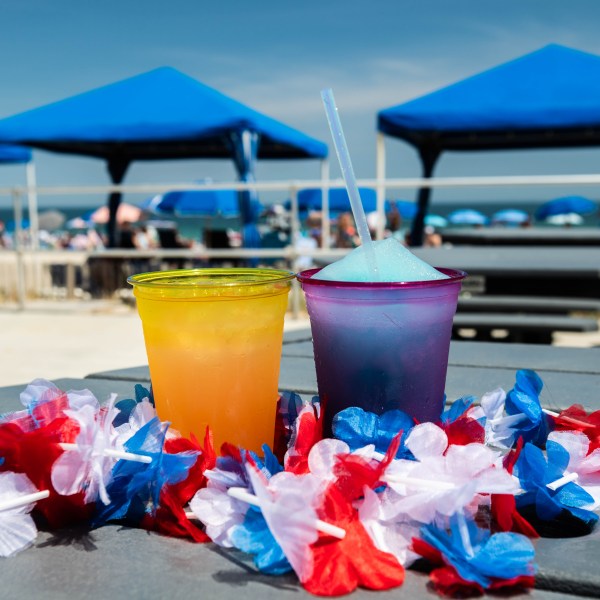 a cup of coffee sitting on top of a picnic table
