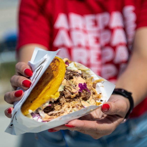 a person holding a piece of cake